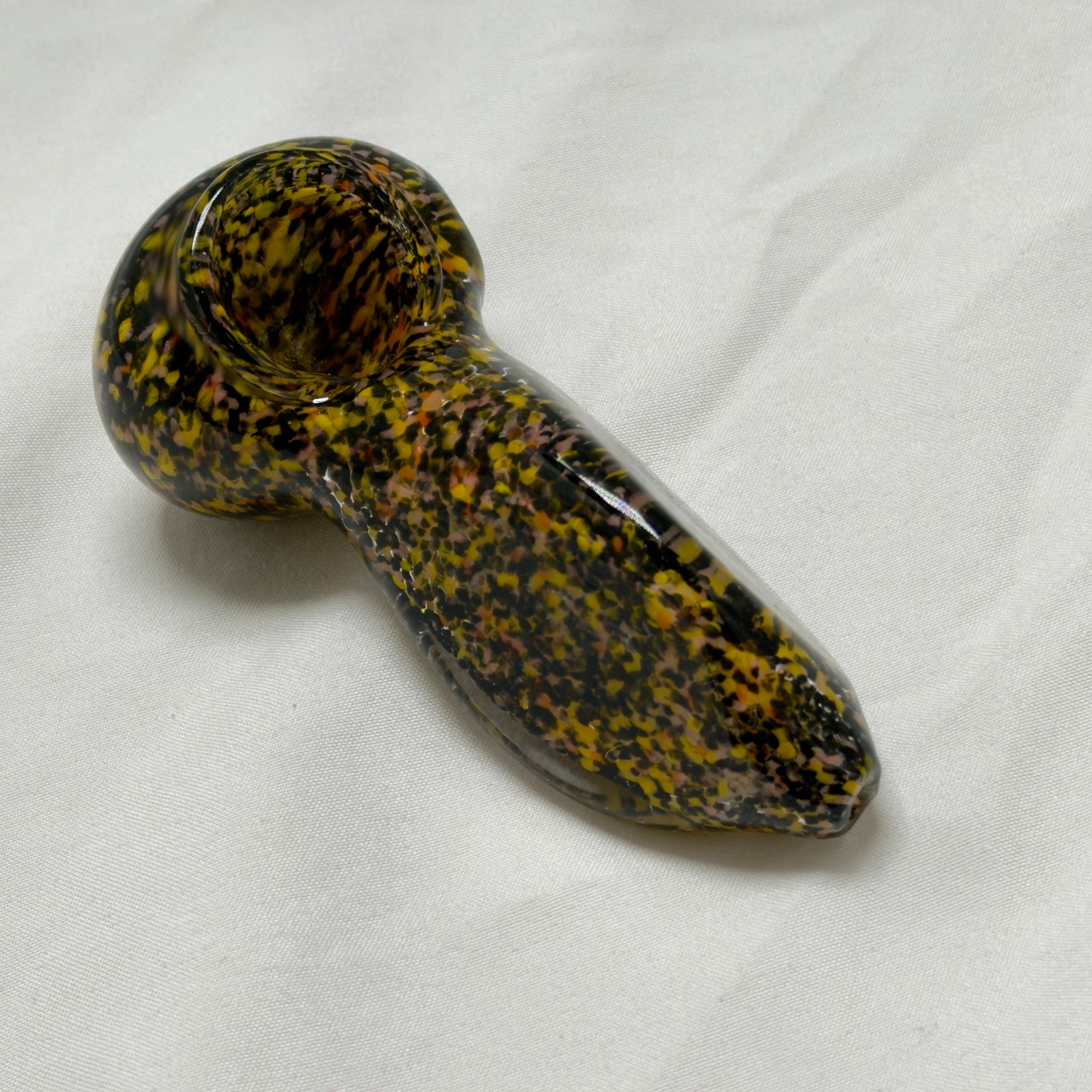 Glass pipe with a speckled pattern on a white background
