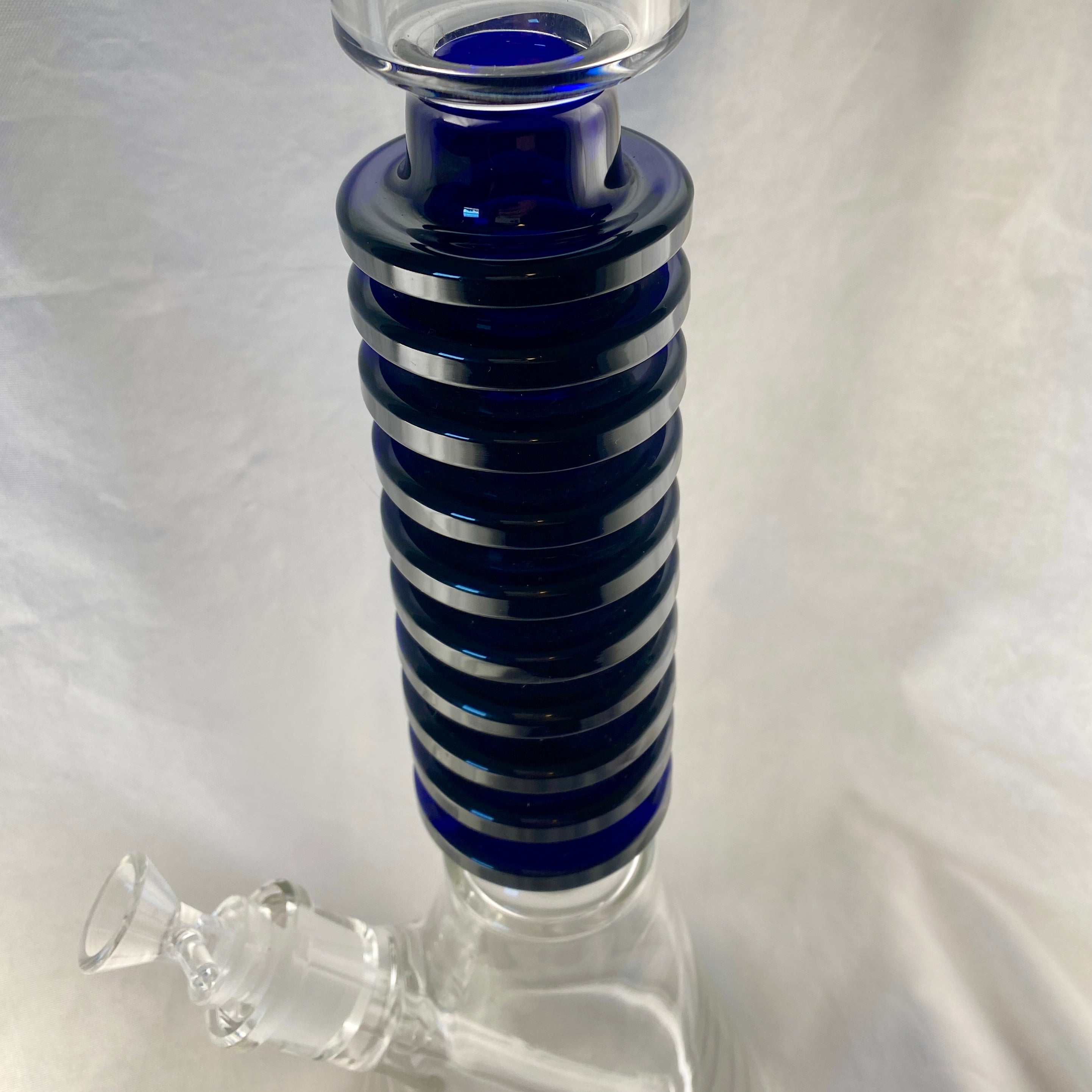 Glass water pipe with blue striped neck on a white background