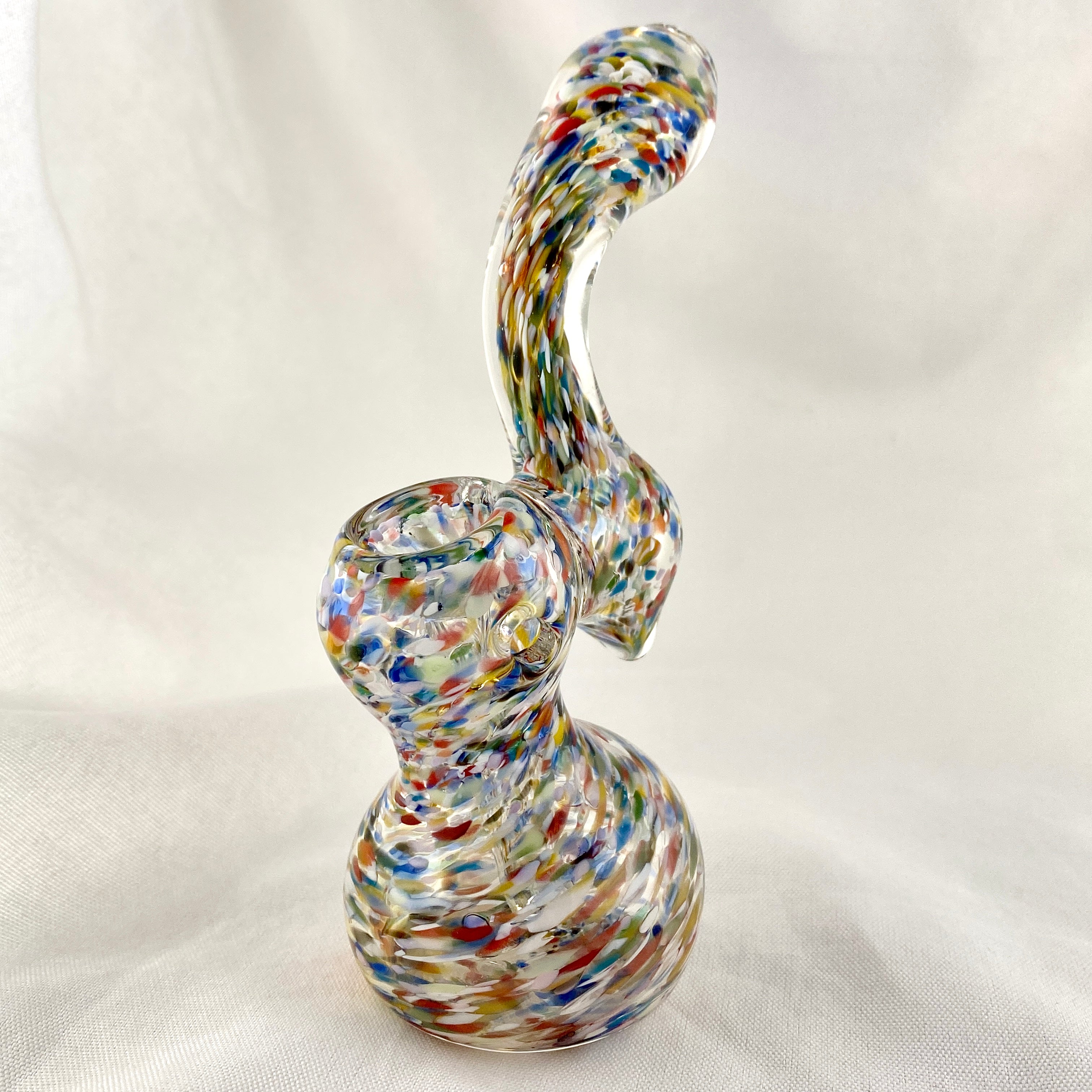 Multicolored glass smoking device on a white background