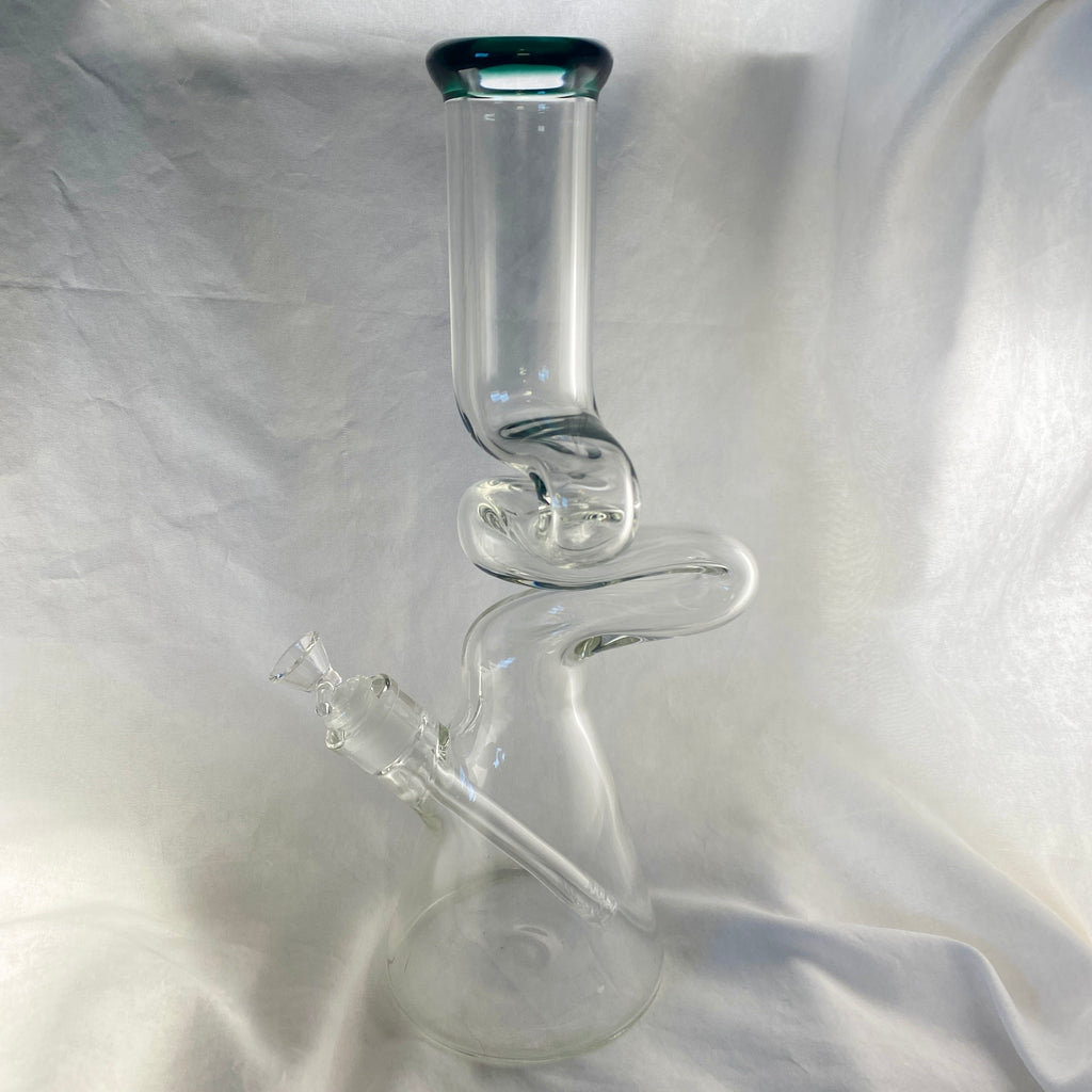 Clear glass water pipe on a reflective silver surface