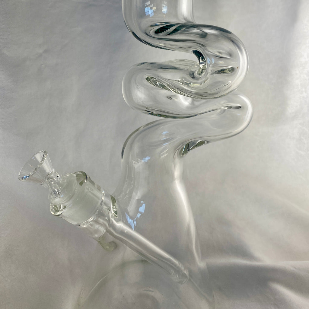 Clear glass smoking device with spiral design on a gray background