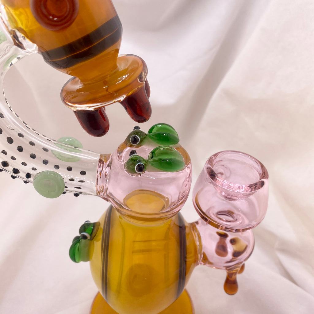 Glass smoking accessory with colorful design on a white background