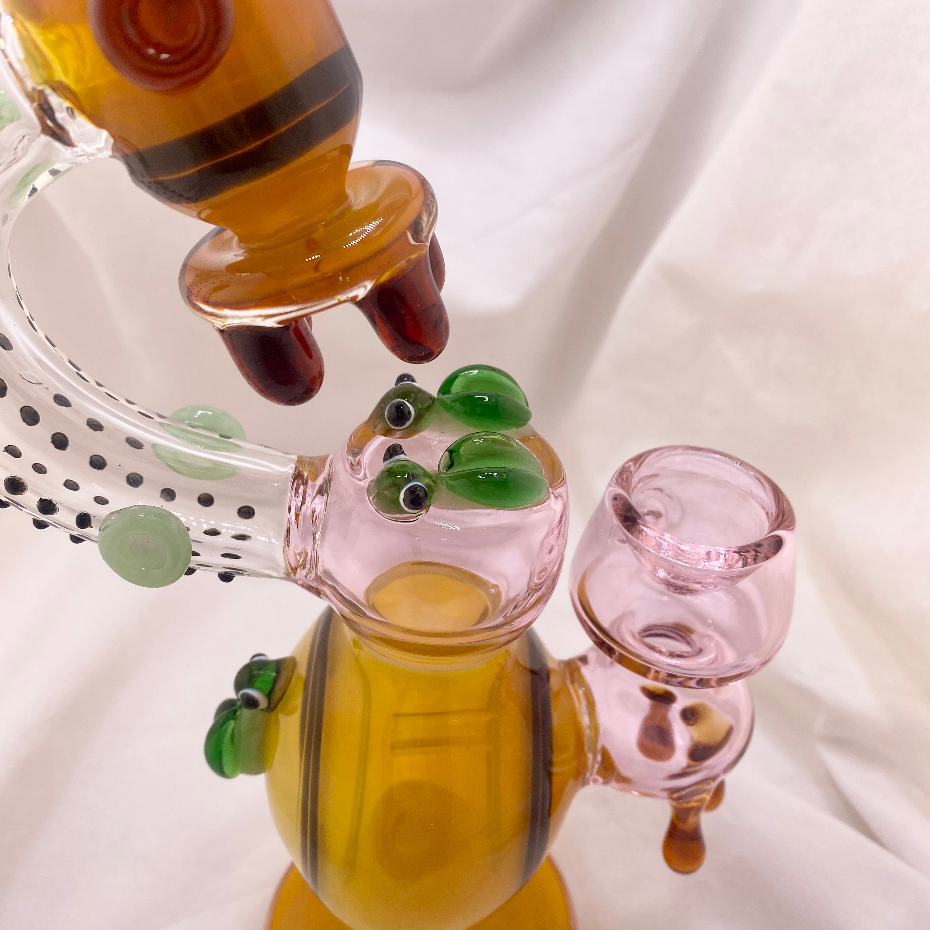 Glass smoking accessory with colorful design on a white background