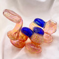 Colorful glass smoking accessory with blue and pink elements on a white background