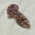 Glass pipe with multicolored speckled pattern on a white background
