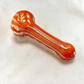 Glass smoking pipe with orange and clear design on a white background