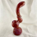 Glass pipe with a twisted design on a white background