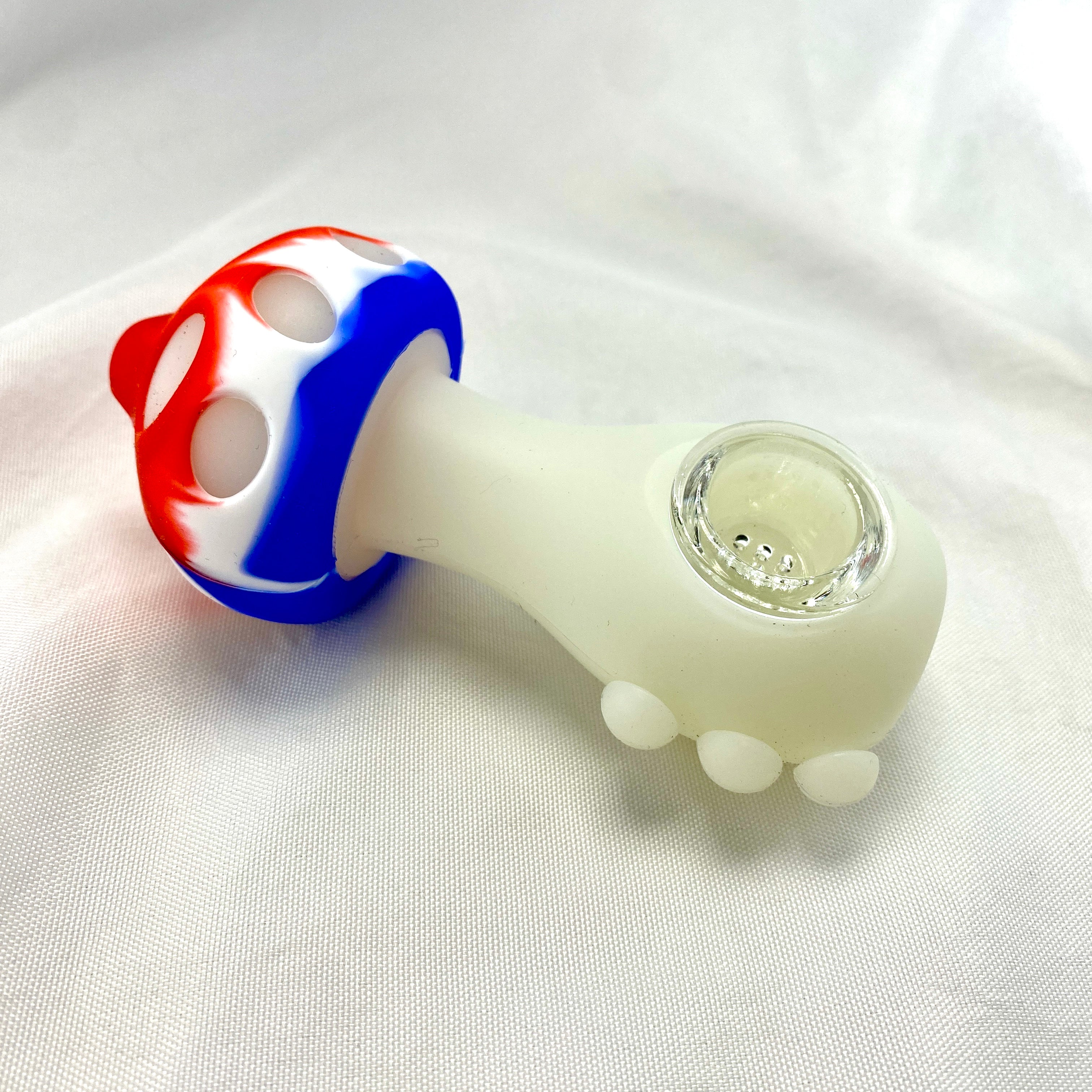 Glass pipe with colorful top on a white fabric background