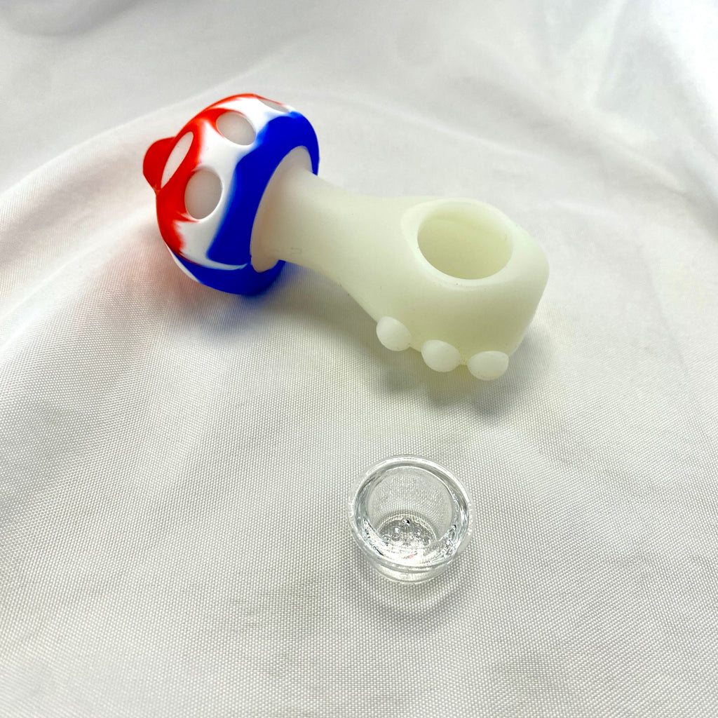 Silicone pipe with red, white, and blue design on a white fabric background