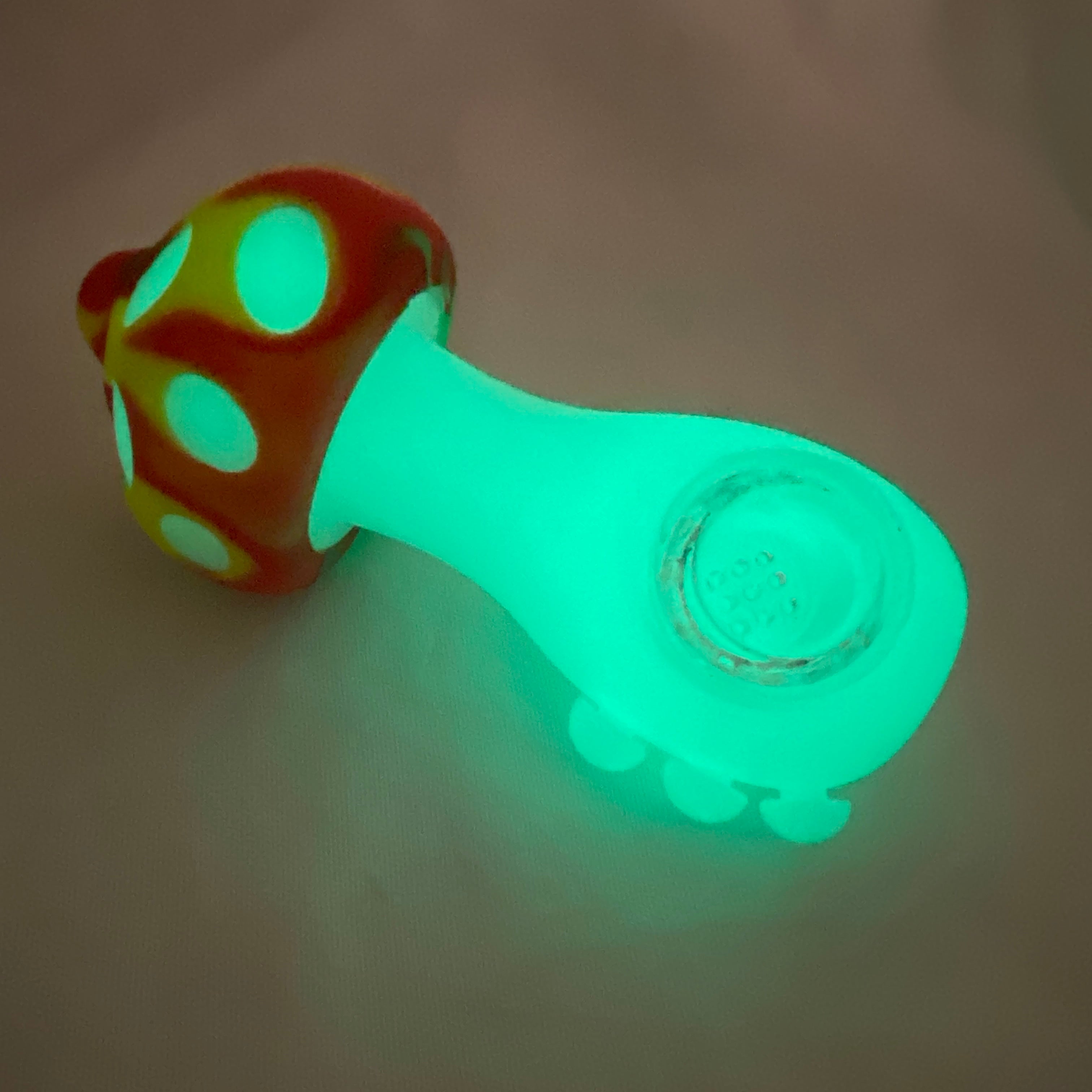 Glowing green mushroom-shaped pipe on a beige background