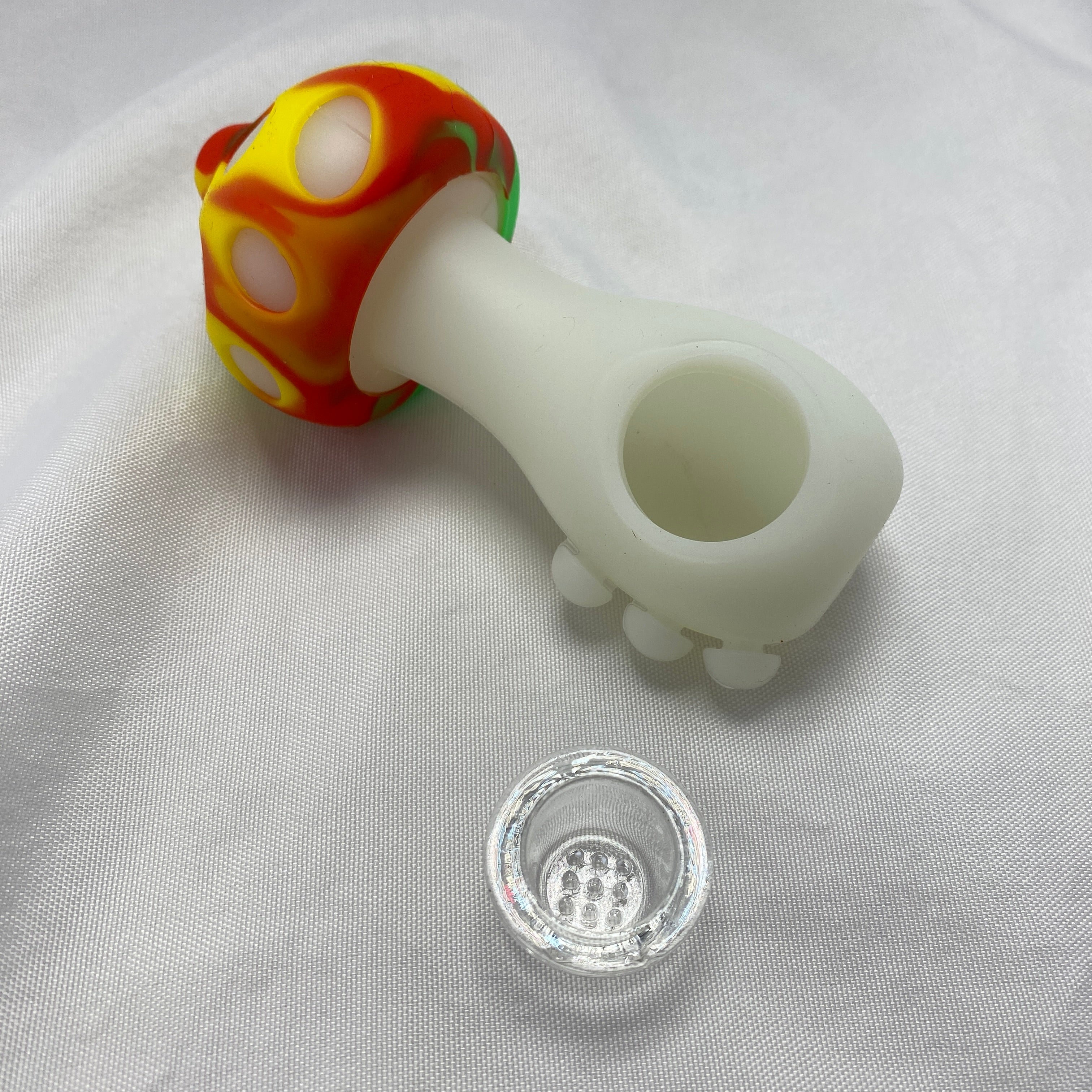 Colorful glass pipe with a white silicone bowl on a light gray background