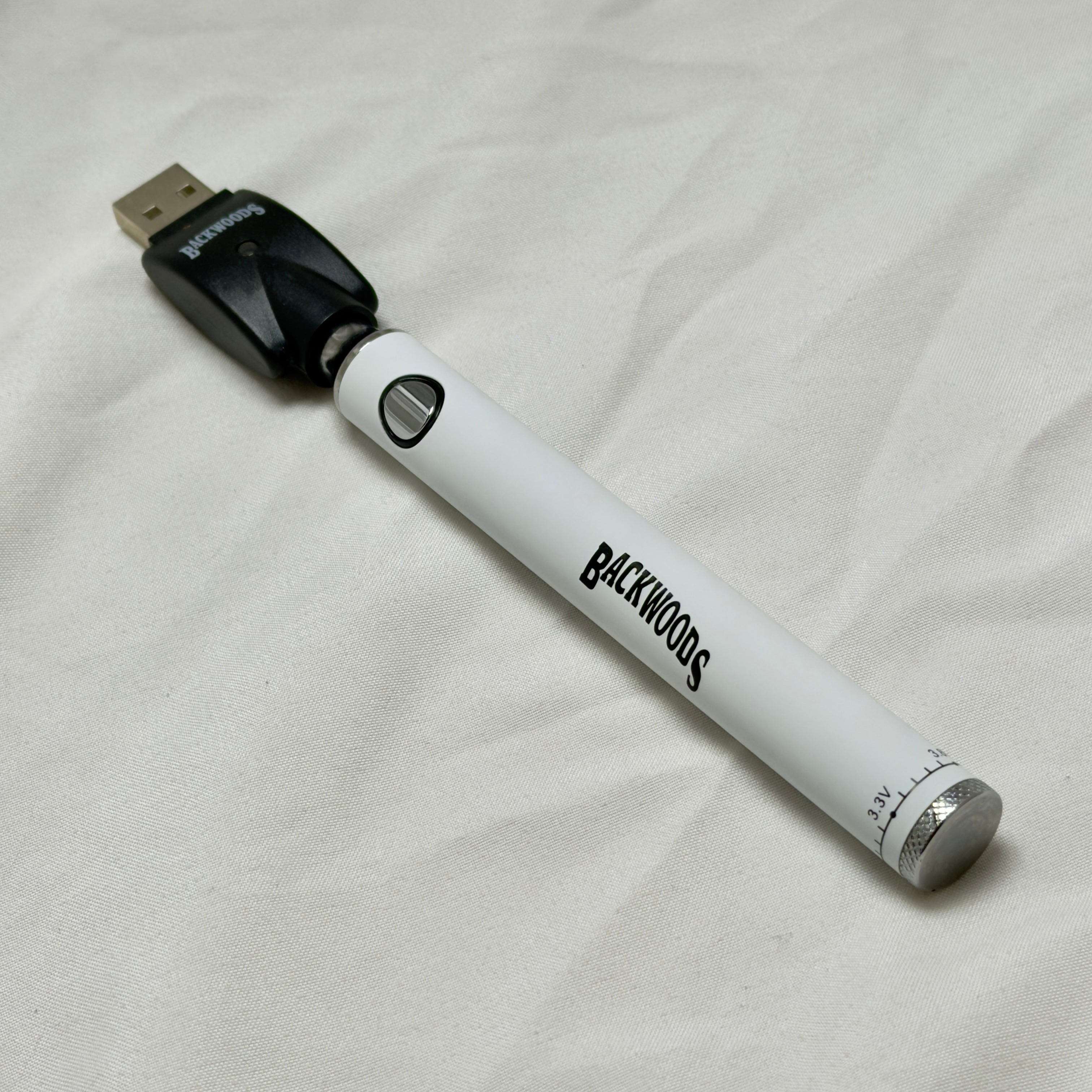White vape pen with 'Backwoods' branding on a light gray background